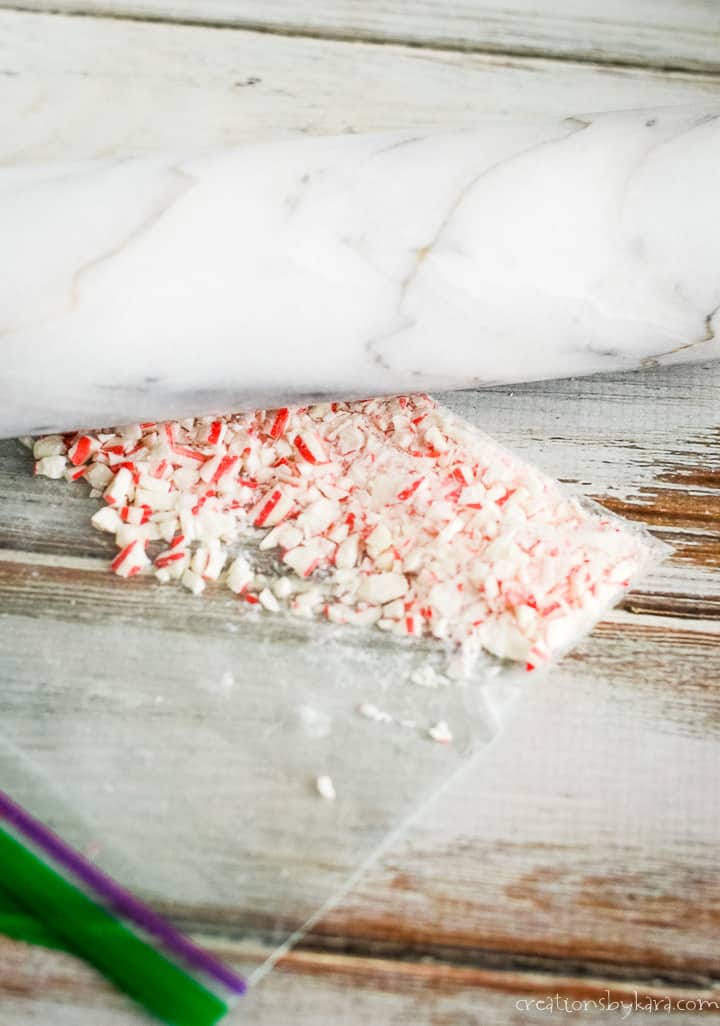 crushed candy canes in a bag with a rolling pin
