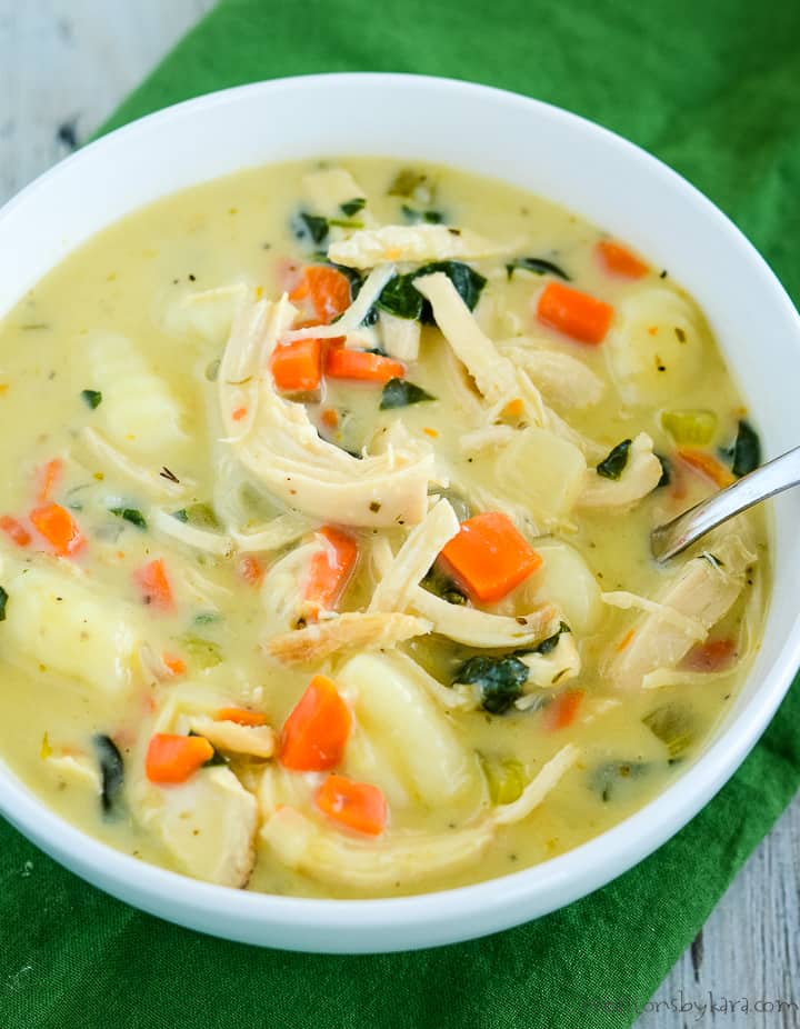Looking for a new favorite soup? Give this easy CHICKEN GNOCCHI SOUP a try. It's ready in about 30 minutes, packed with flavor, and so comforting! It's a tasty Olive Garden copycat the whole family will love. #chickengnocchisoup #copycatrecipe #olivegardensoup #gnocchisoup -from Creations by Kara overhead shot of bowl of olive garden chicken and gnocchi soup