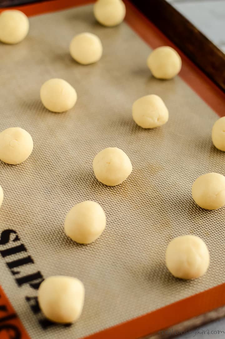 almond sugar cookie dough balls on a baking sheet