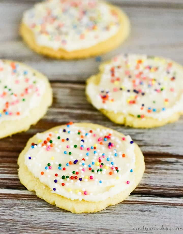 almond cookies with powdered sugar frosting and sprinkles