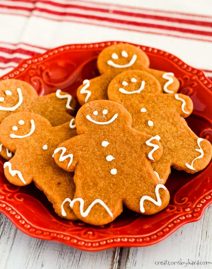plate of gingerbread man cutout cookies decorated with white chocolate