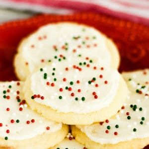 almond christmas cookies with frosting and sprinkles