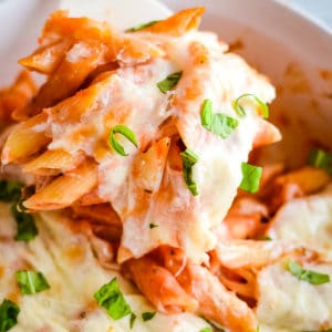 scoop of baked penne pasta with cheese