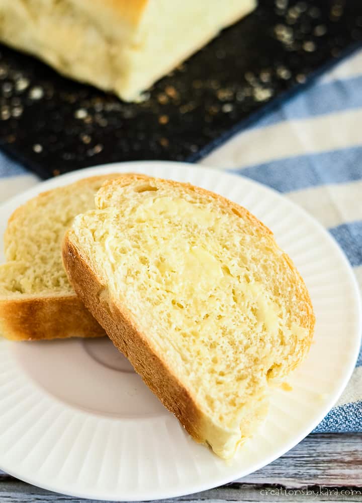 slices of buttered french bread on a white plate