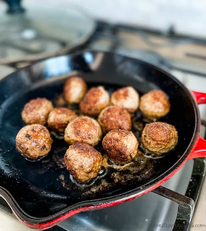 meatballs browning in a skillet