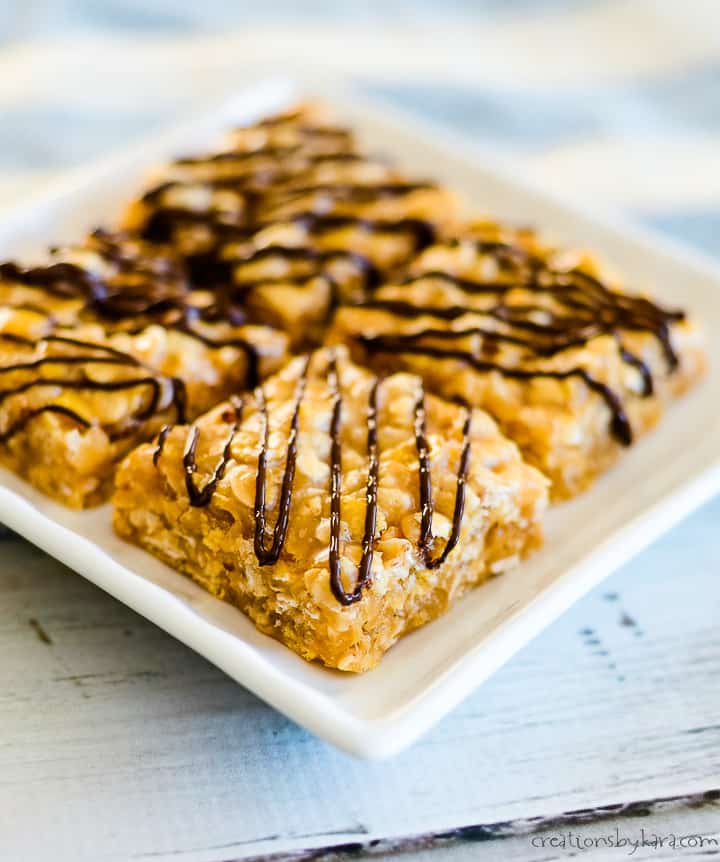 plate of no bake peanut butter bars drizzled with chocolate