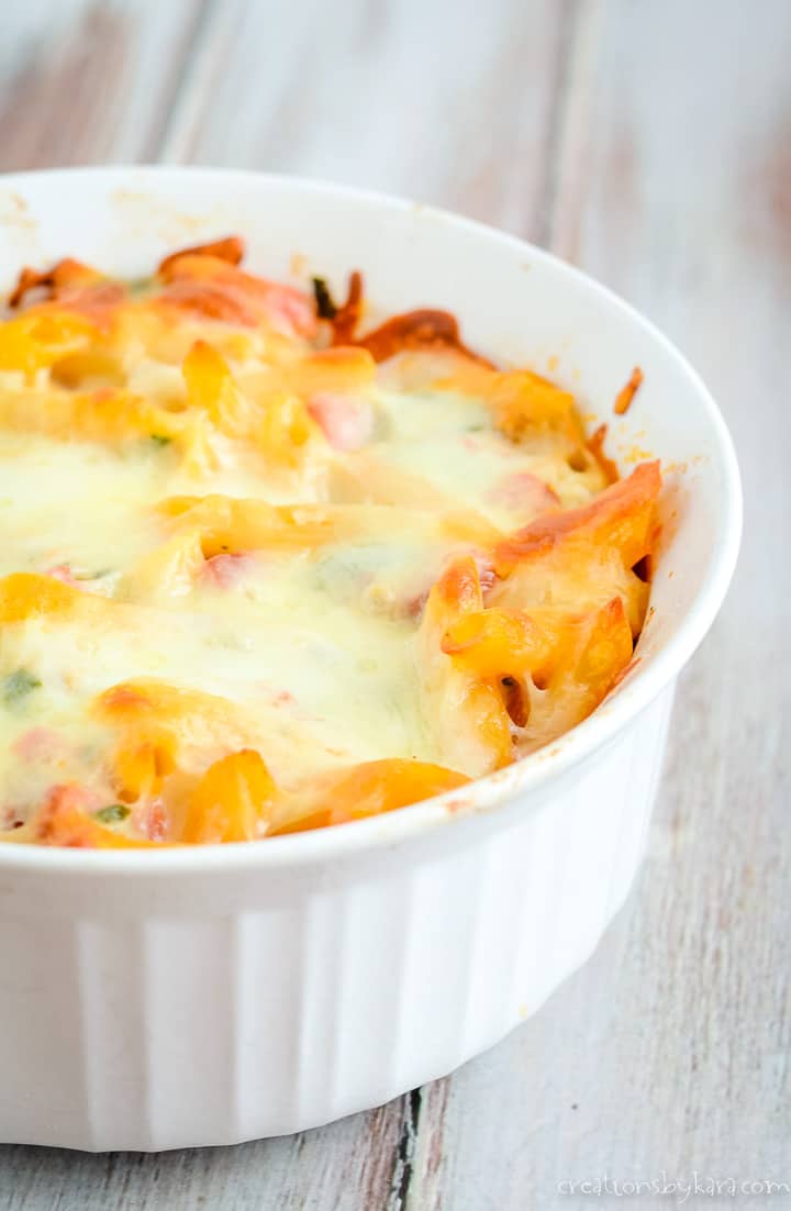 casserole dish of pasta with smoked sausage, topped with cheese