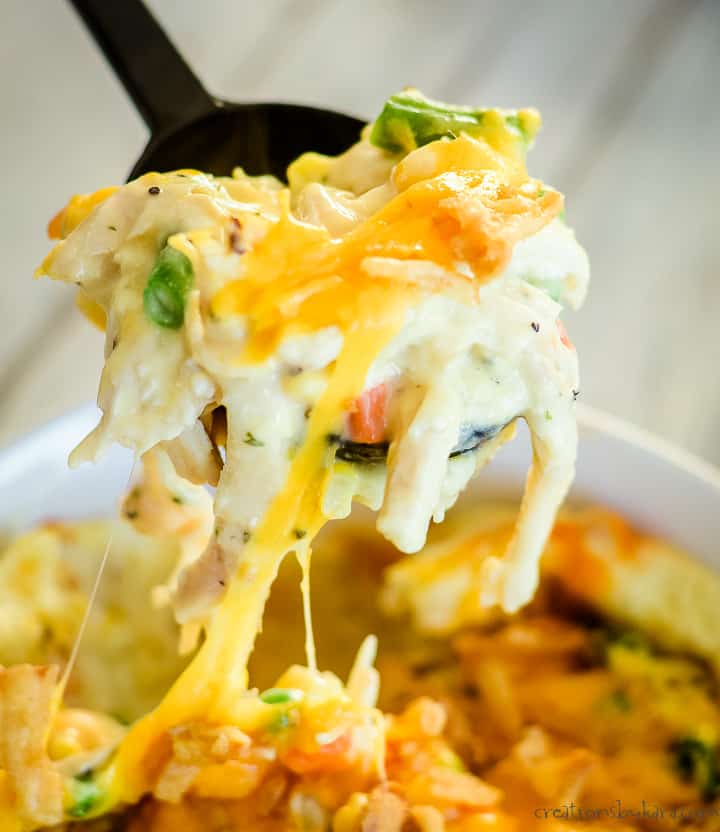 cheese melting off a scoop of chicken mashed potato casserole