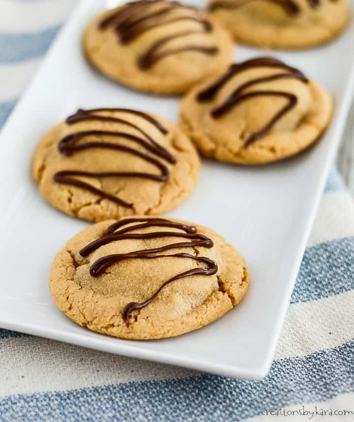 tray of peanut butter snickers cookies drizzled with melted chocolate