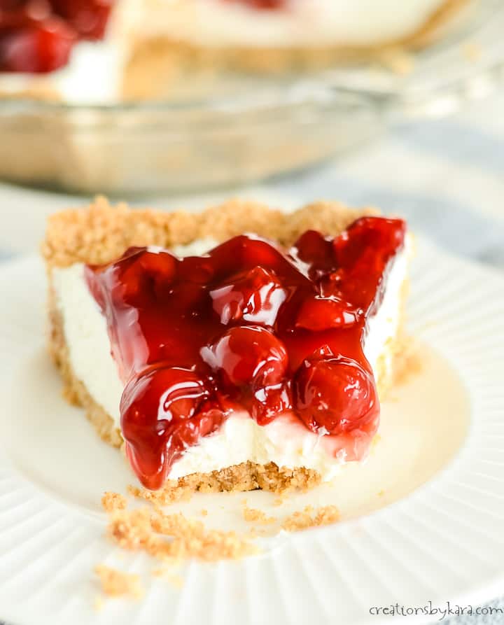 cherry slice of cheesecake no bake pie with a bite taken out of it