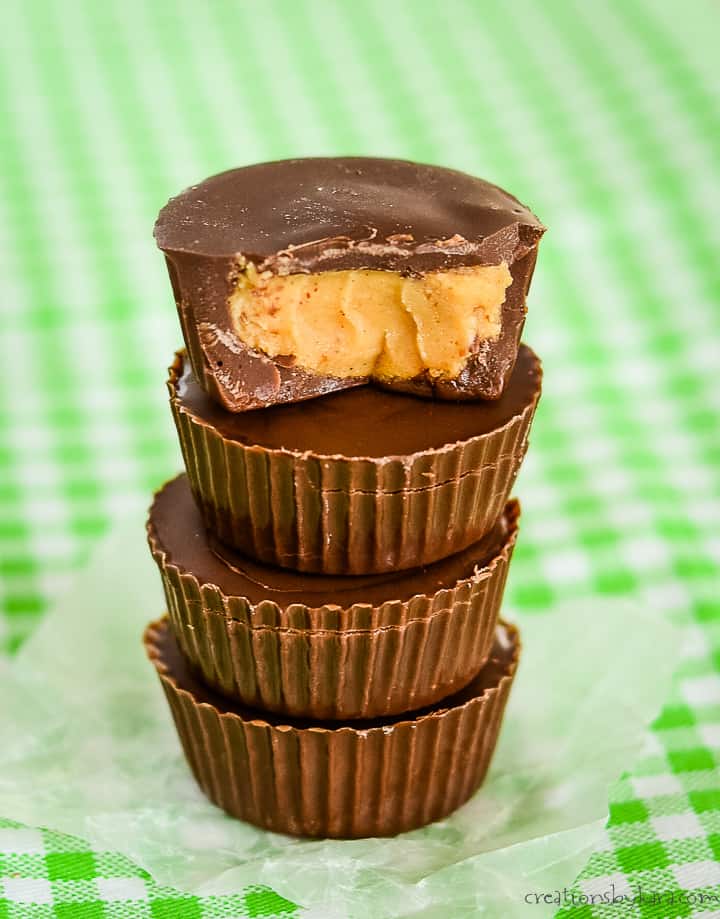 stack of keto peanut butter cups, one with a bite taken out of it