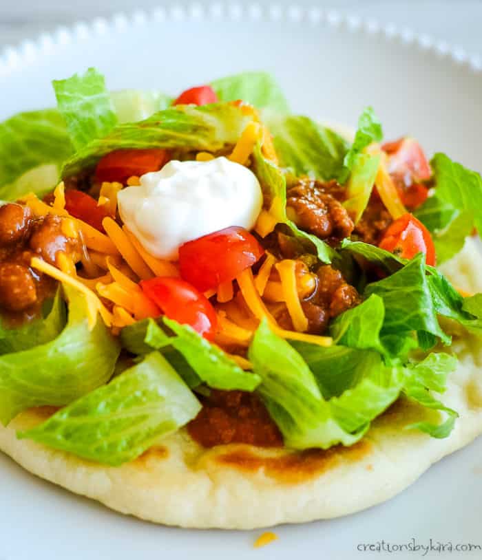 native american taco on a plate with all the taco toppings