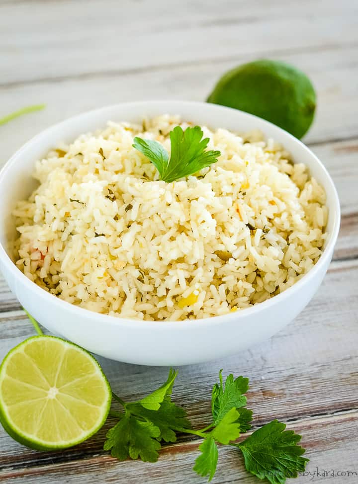 bowl of cilantro lime rice with cilantro leaves as garnish