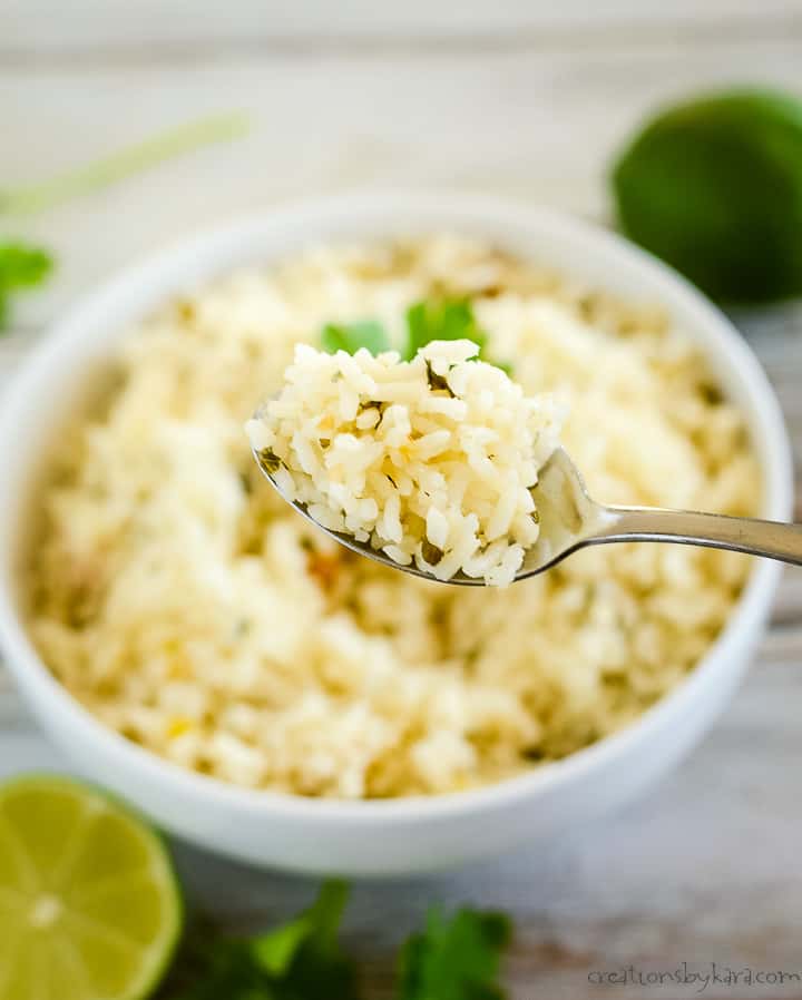 spoonful of rice being held over a bowl of rice