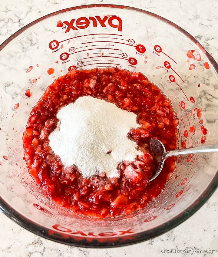 bowl of crushed strawberries with powdered pectin