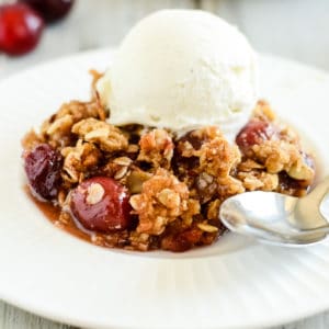 plate of cherry crisp with a spoon