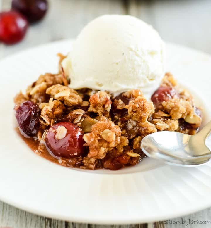 plate of cherry crisp with a spoon