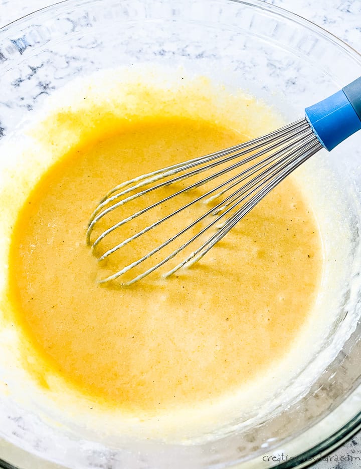 bowl of cornbread muffin batter with a whisk