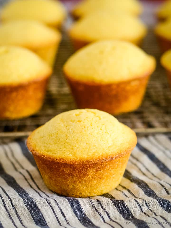 corn bread muffin on a towel with muffins in the background