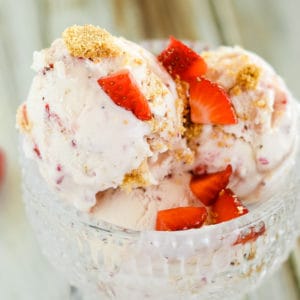 bowl of strawberry cheesecake ice cream with fresh berries