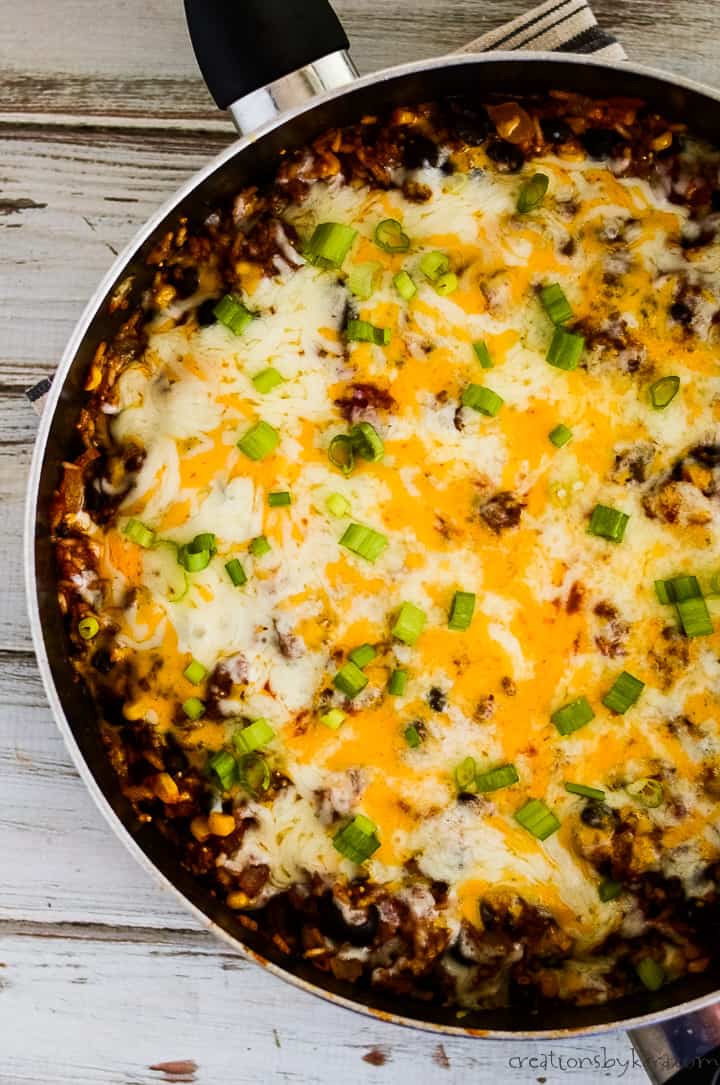 overhead shot of mexican rice casserole topped with melted cheese