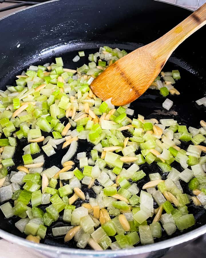 sauteed celery onion and almonds in a skillet