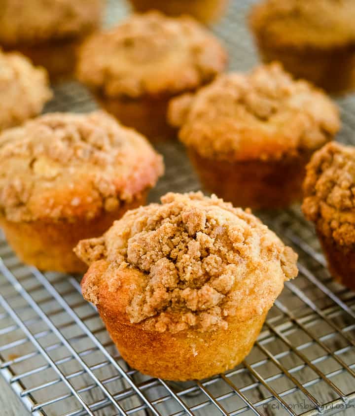 apple crumble muffins on wire cooling racks.
