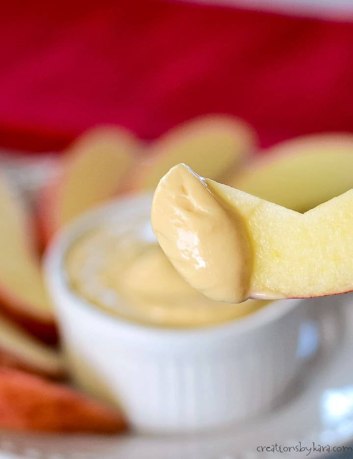 caramel cream cheese apple dip on an apple slice