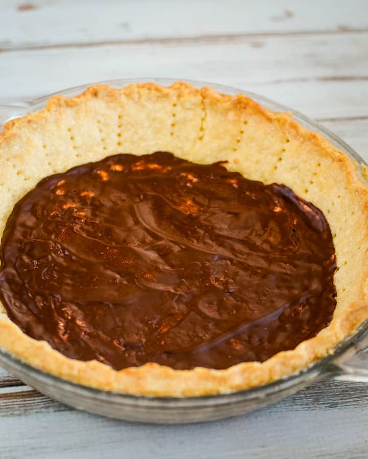 baked pie shell lined with melted chocolate