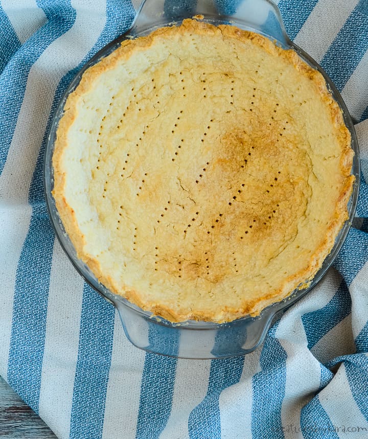 baked oil pie crust on a striped dish towel