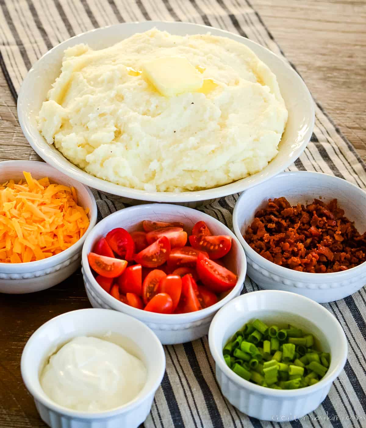 mashed potatoes with bowls of toppings