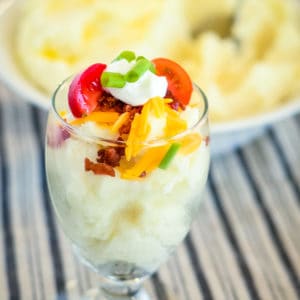 glass with mashed potatoes and all the toppings