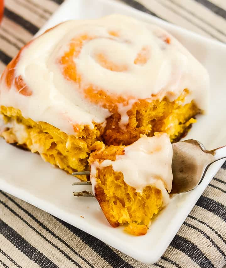 pumpkin spice roll on a plate with a bite on a fork.