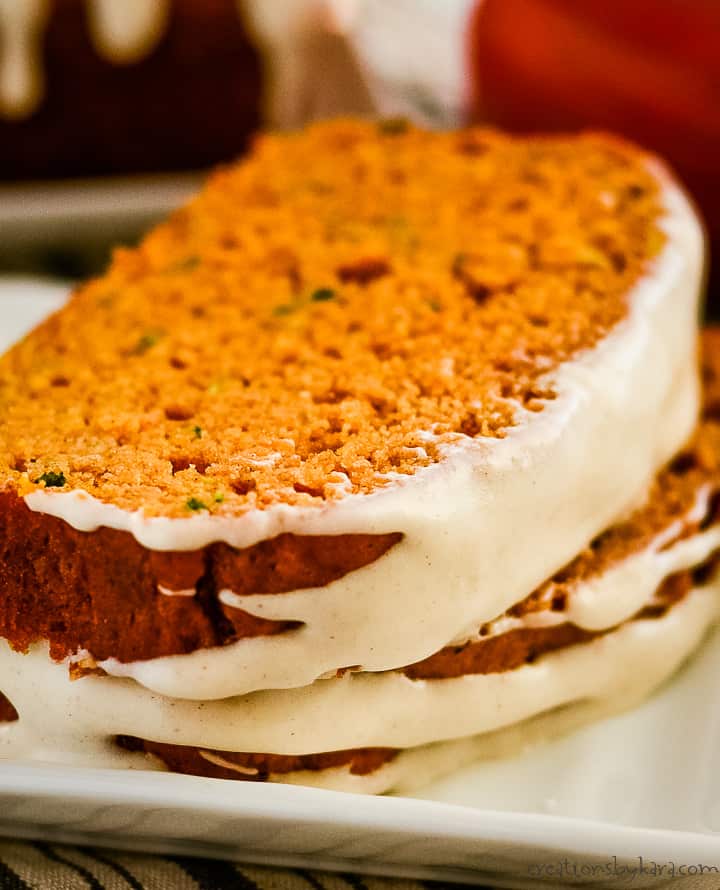 close up of frosting on slices of pumpkin zucchini bread