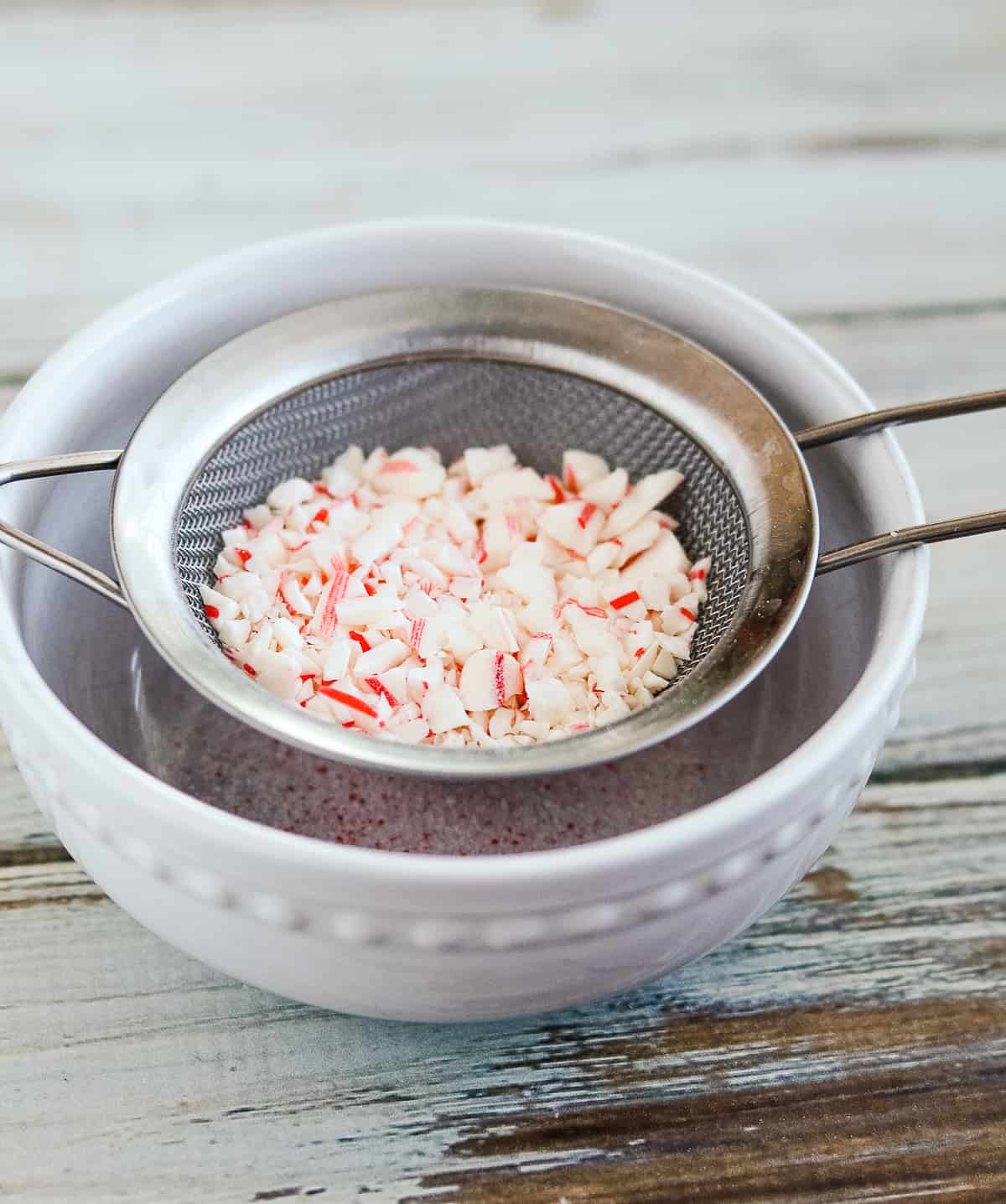 crushed candy canes in a strainer