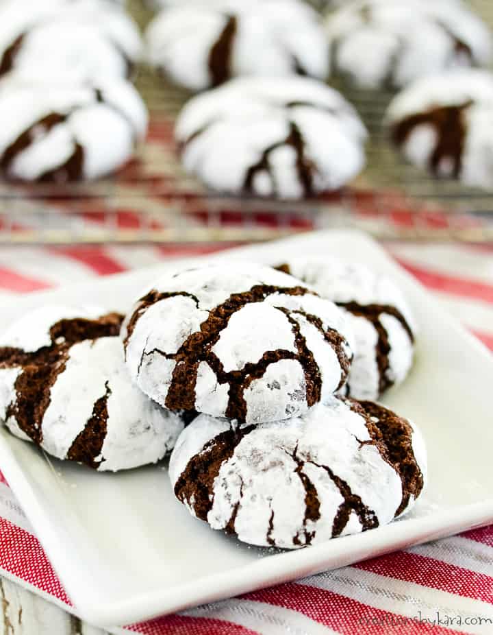 plate of chocolate crinkles with more cookies in the background
