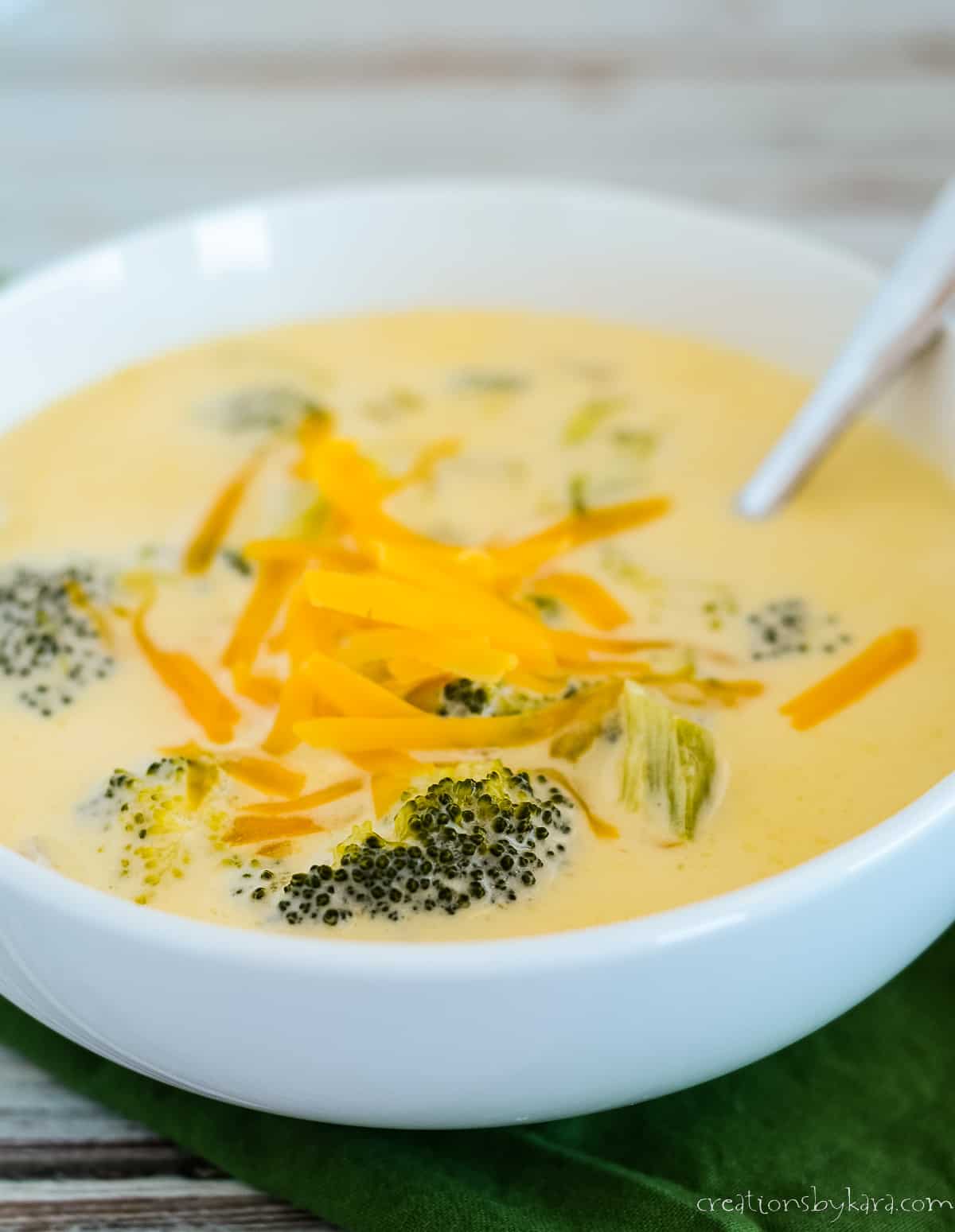 bowl of keto broccoli cheese soup with a spoon