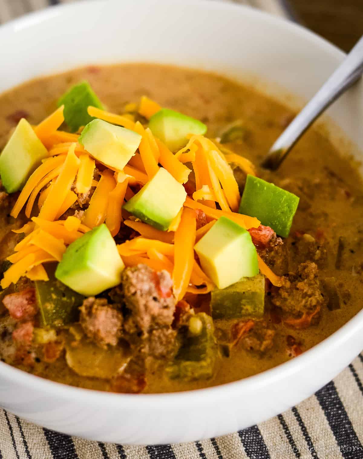bowl of taco soup with rotel, avocadoes, and cheese