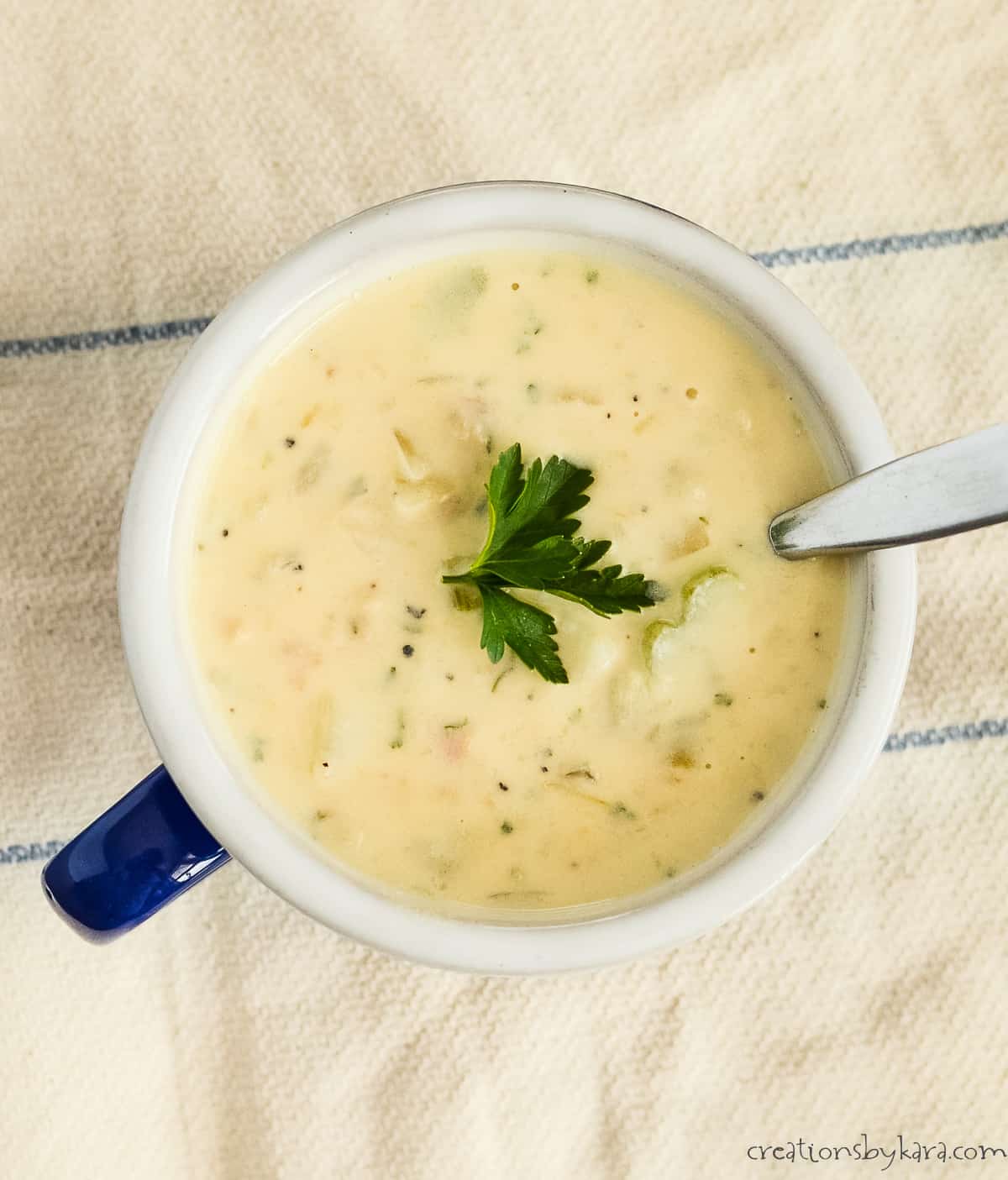 overhead shot of bowl of homemade clam chowder with a spoon