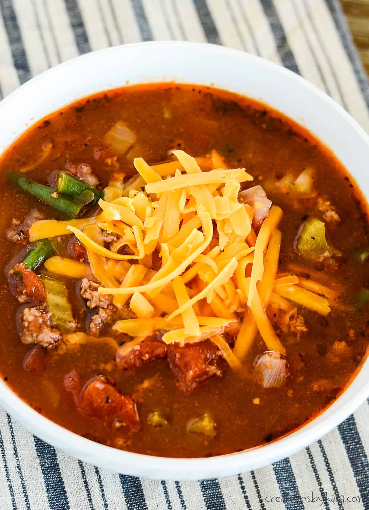 overhead shot of bowl of soup topped with cheese