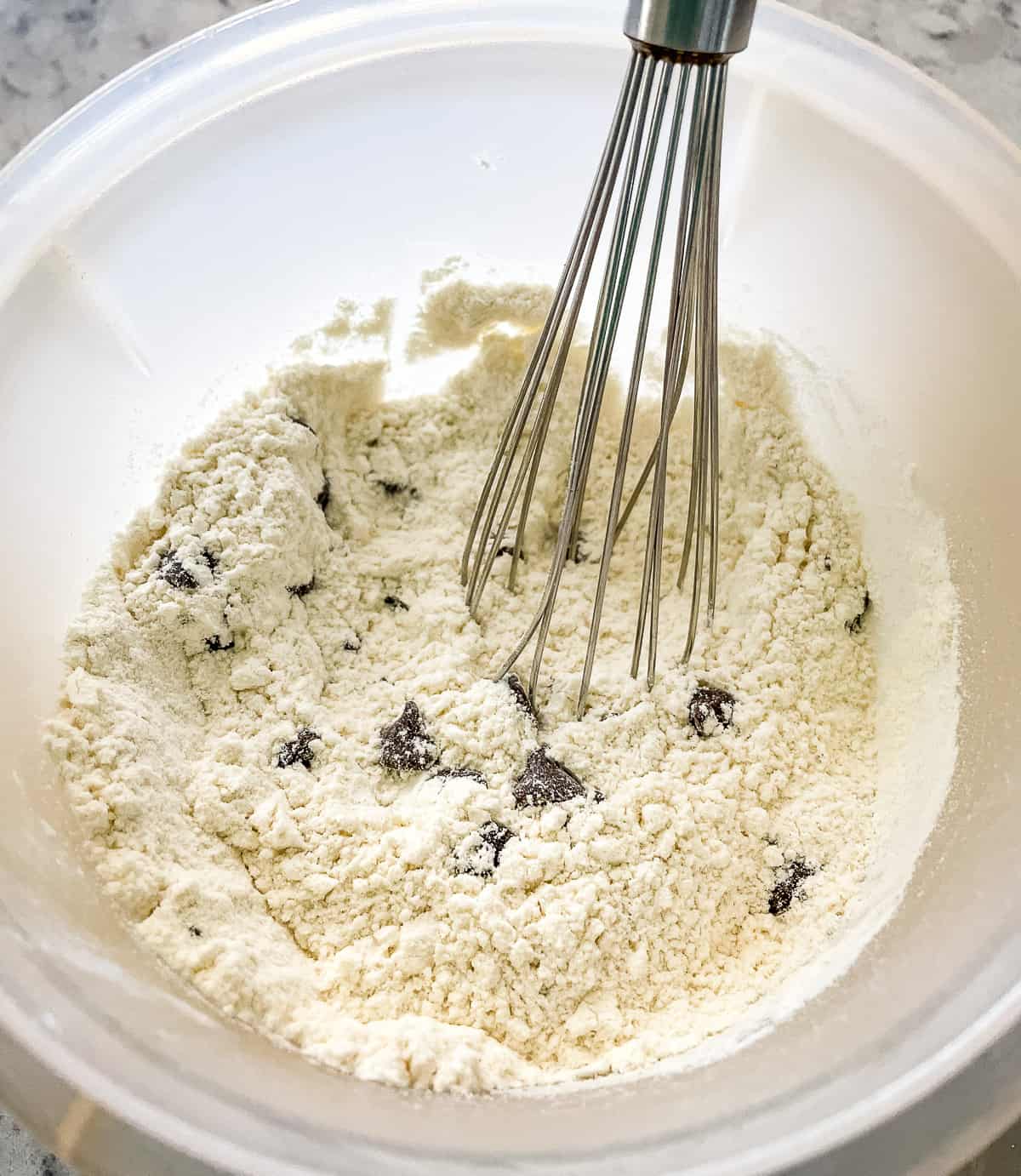 adding chocolate chips to dry ingredients