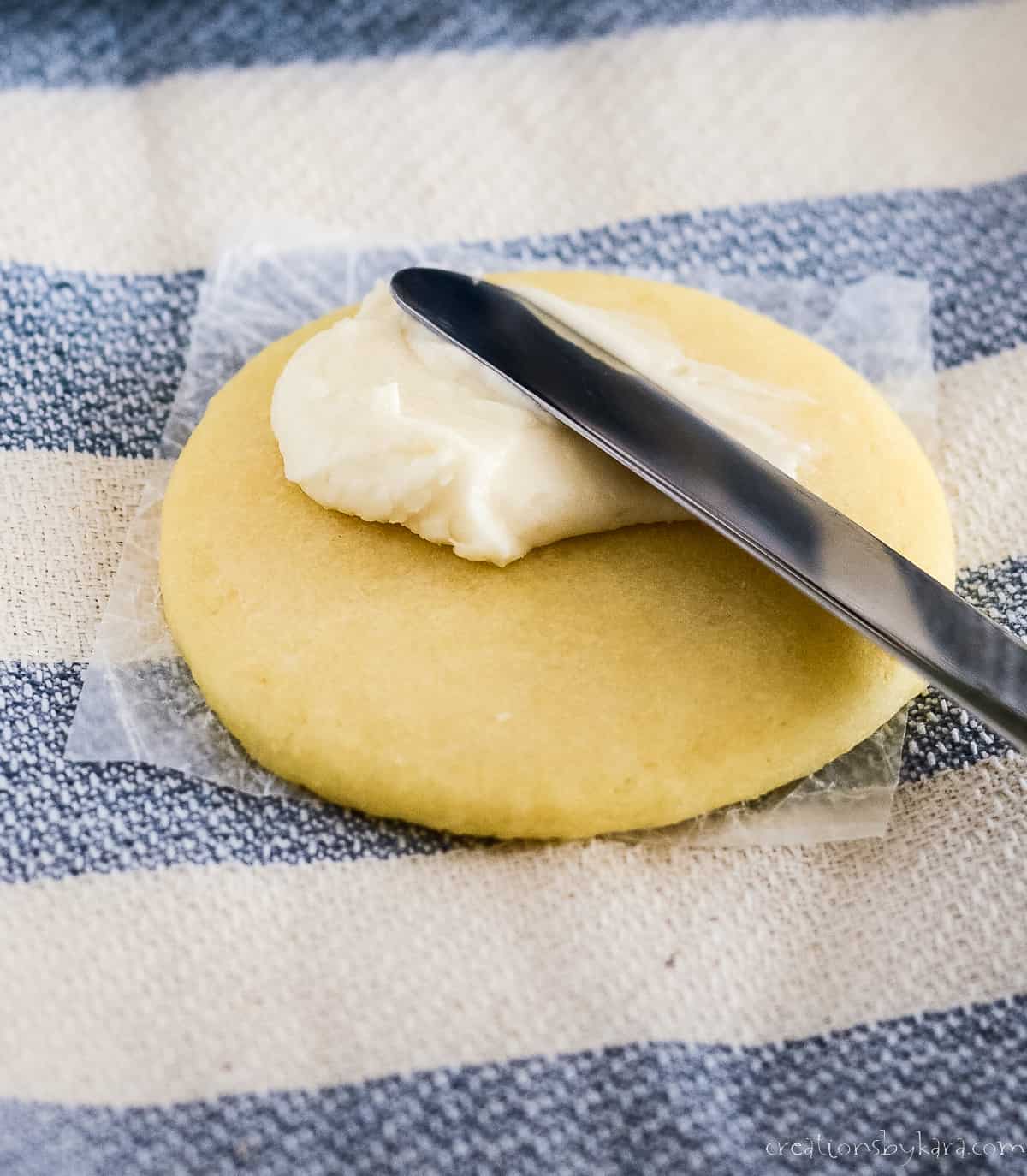frosting being spread on a cookie