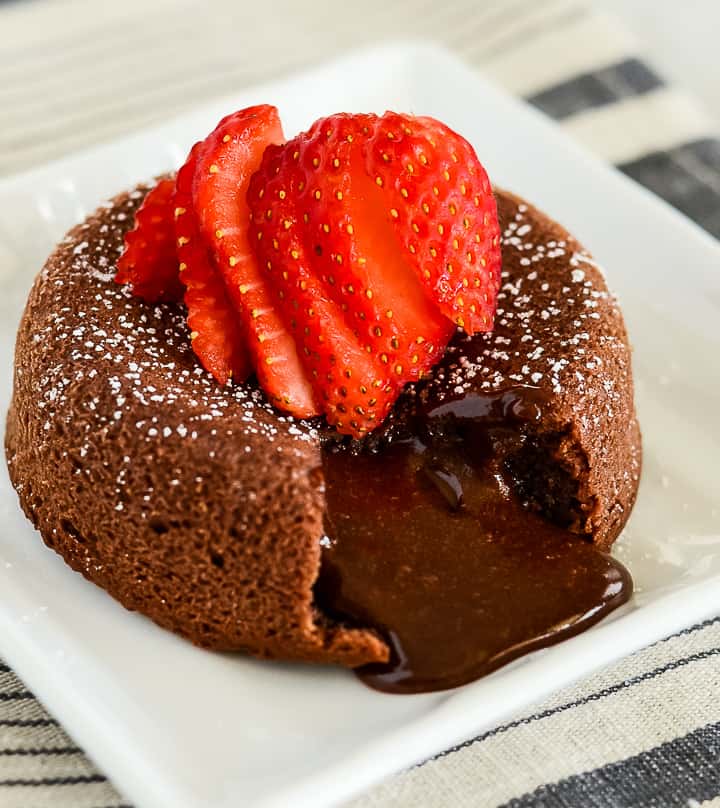 lava cake topped with sliced strawberries