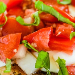 baked bruschetta chicken topped with tomatoes and fresh basil