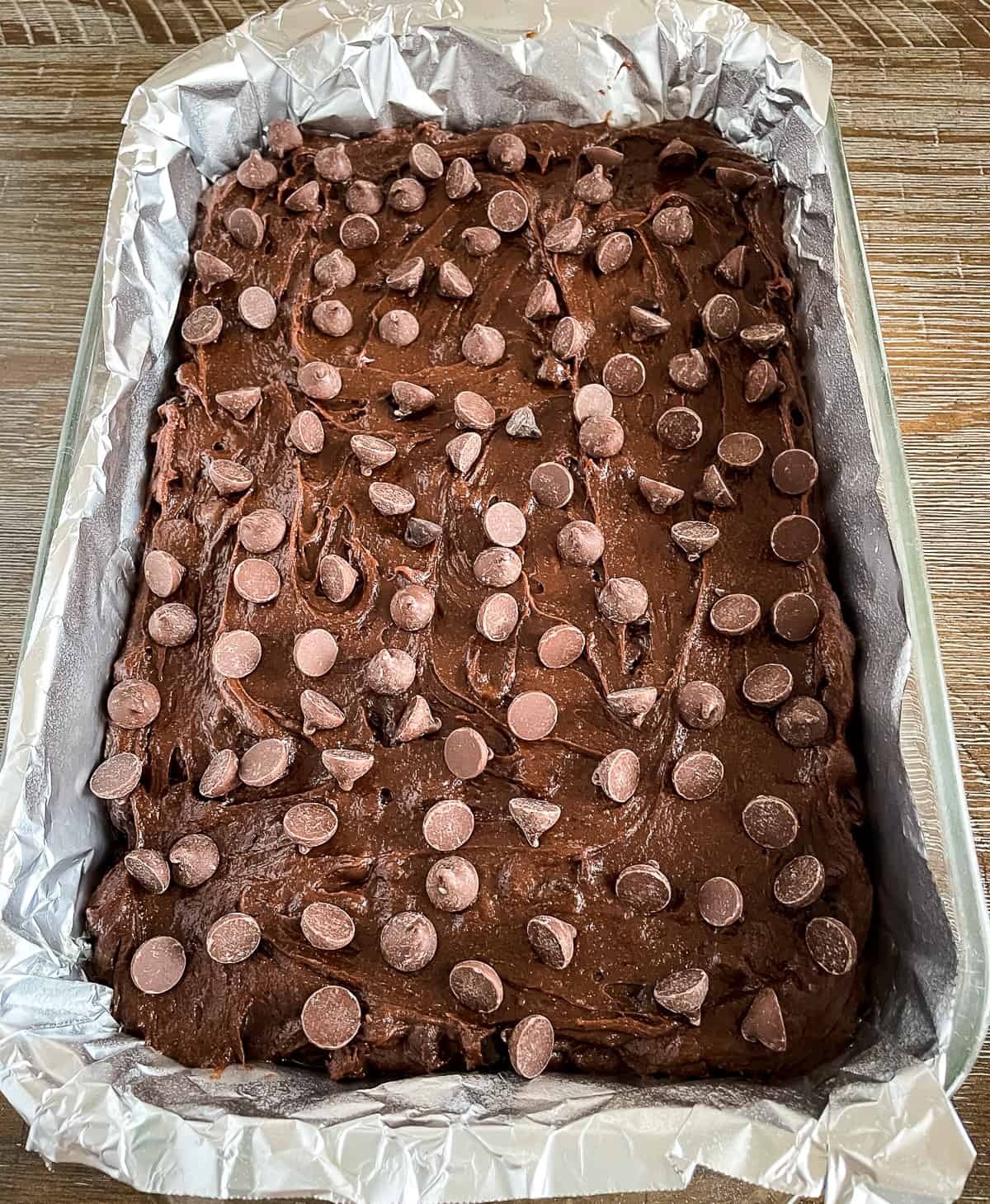pan of unbaked brownies sprinkled with chocolate chips