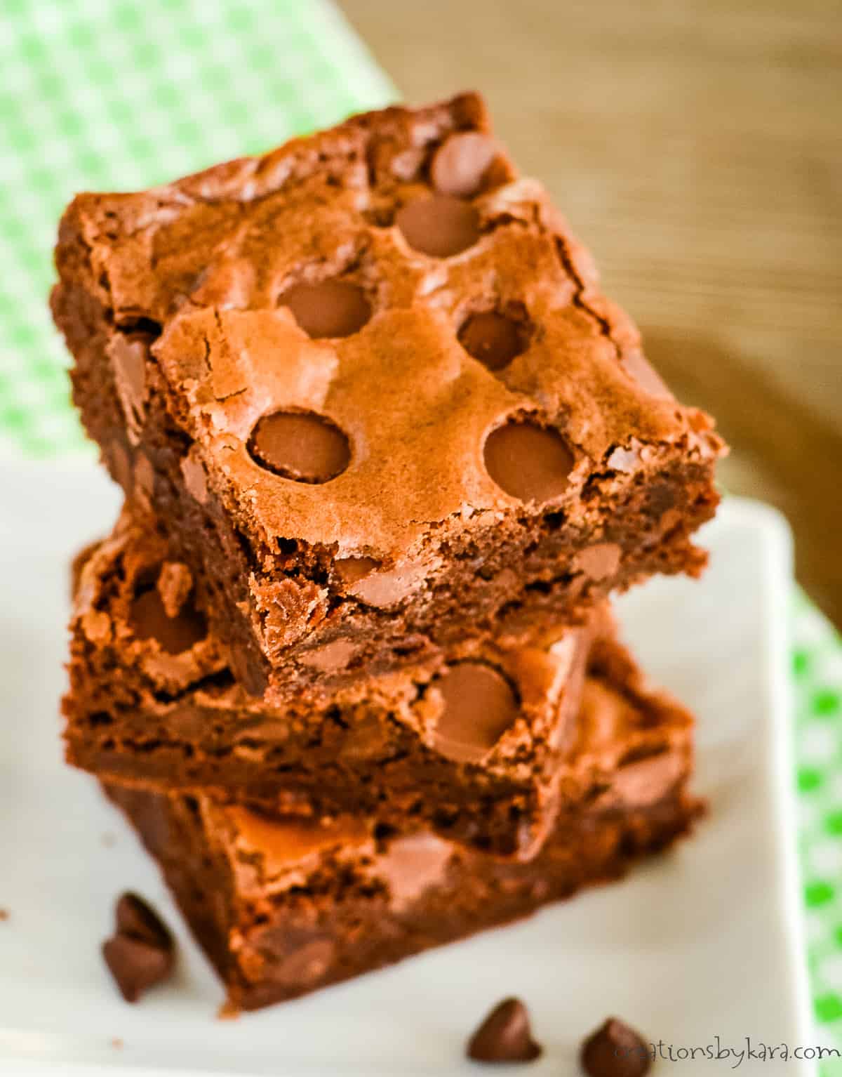 stack of brownies with chocolate chips on a small white plate