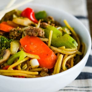 bowl of ground beef lo mein with chopsticks