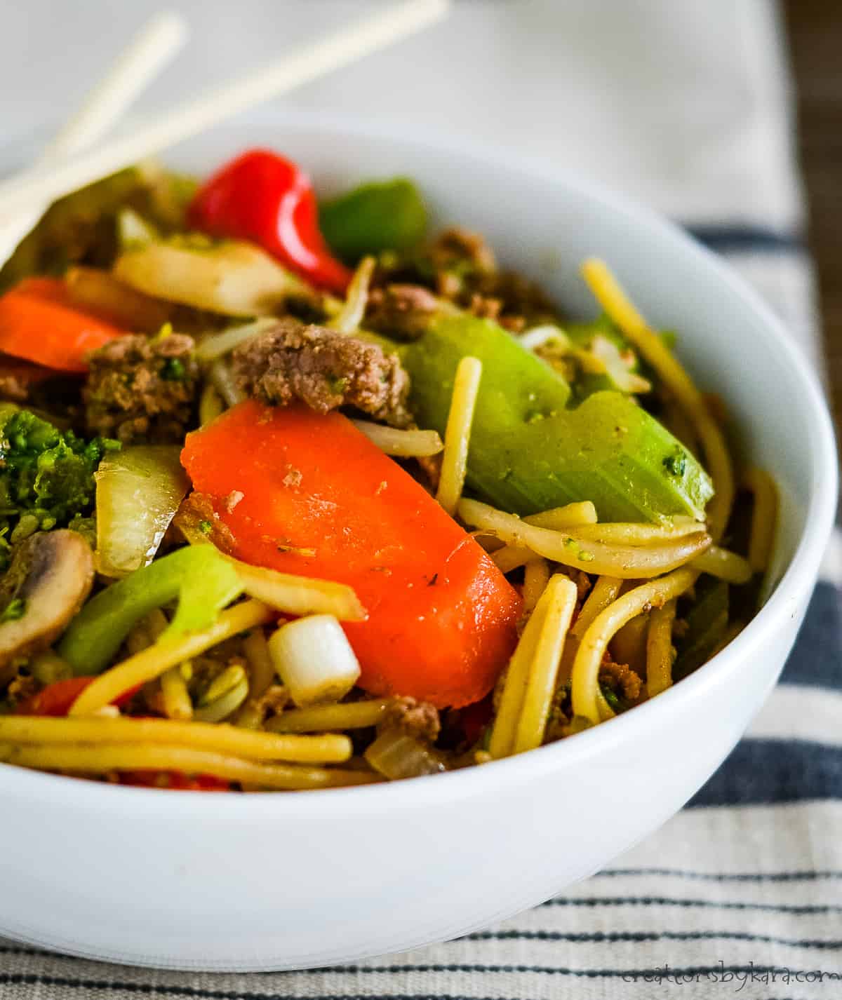 bowl of ground beef lo mein with chopsticks