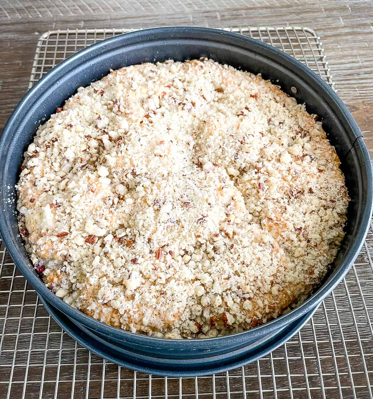 pan of raspberry crumb cake on a cooling rack