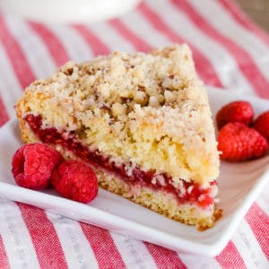 slice of coffee cake with raspberries on a plate